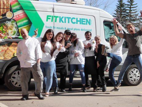 Fit Kitchen team posing in front of the company Van