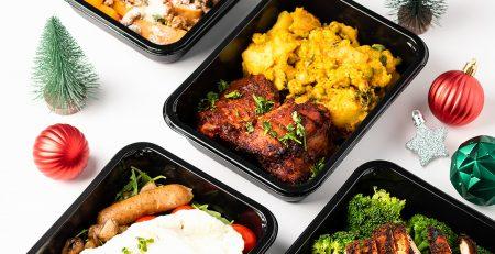 4 fit kitchen meals with Christmas décor arranged around the meals.