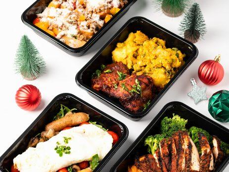 4 fit kitchen meals with Christmas décor arranged around the meals.