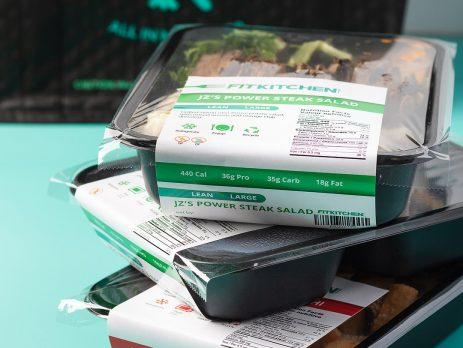Stack of pre-packaged Fit Kitchen meals
